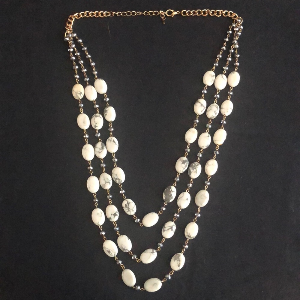 Triple strand gold tone necklace with marbled stones